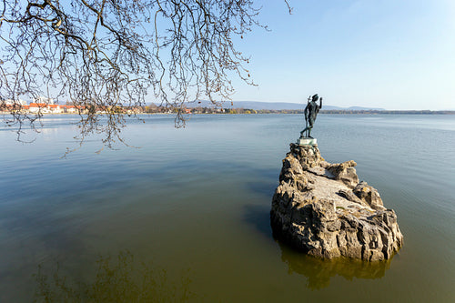 The old lake in Tata, Hungary with the statue of Saint John.