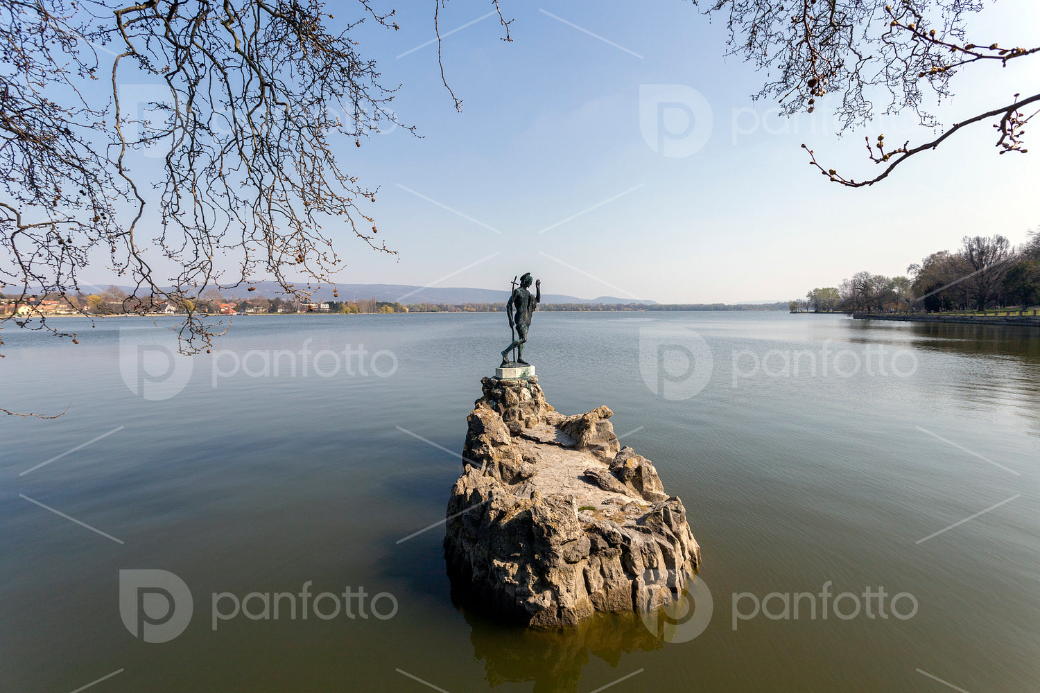 The old lake in Tata, Hungary with the statue of Saint John.
