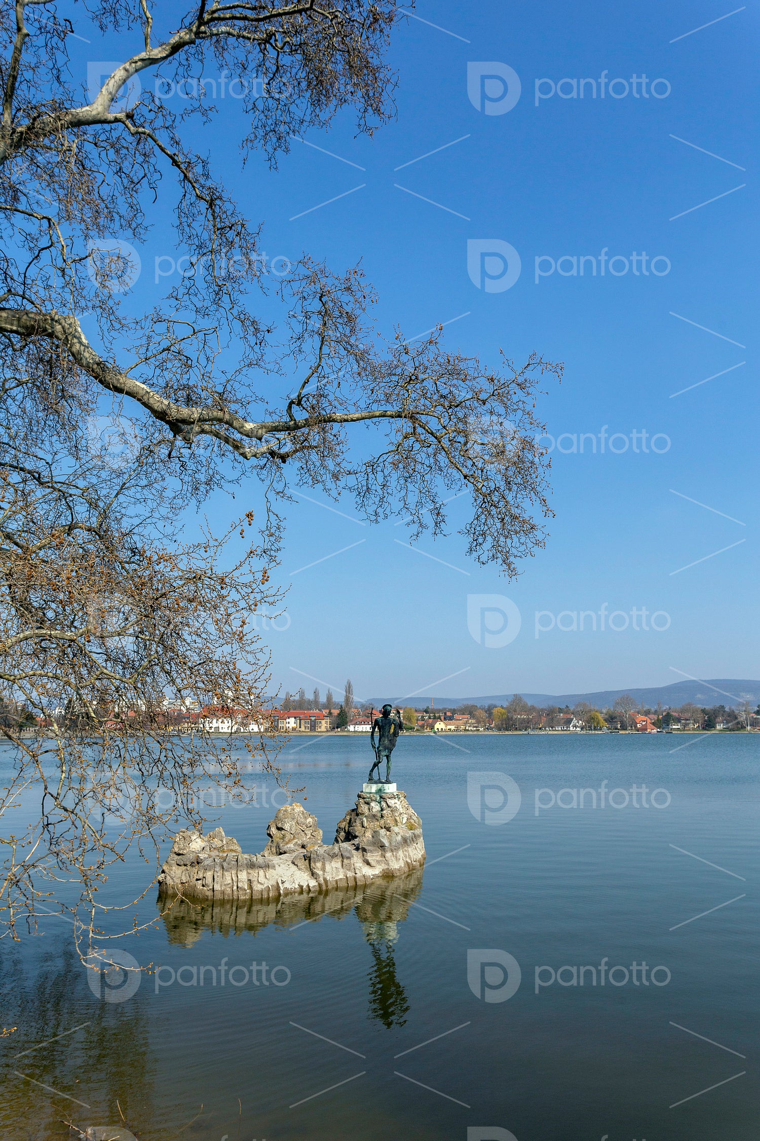 The old lake in Tata, Hungary with the statue of Saint John.