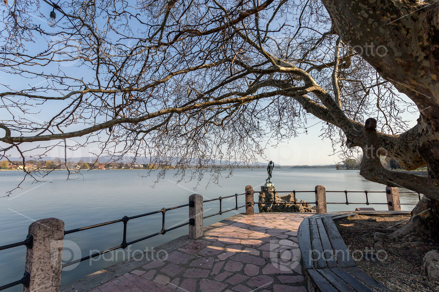 The old lake in Tata, Hungary with the statue of Saint John.