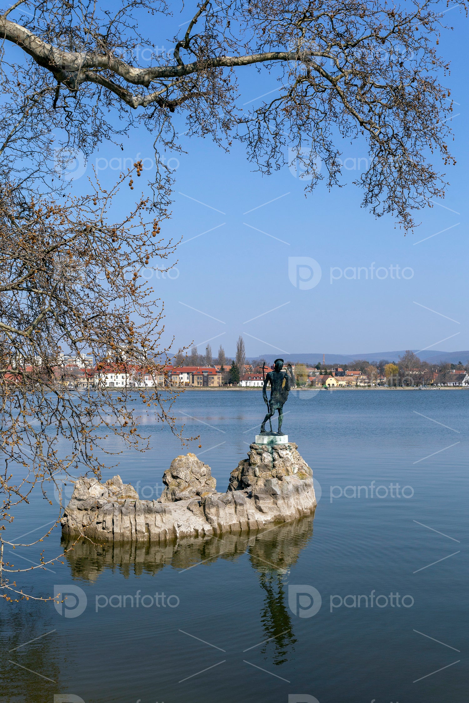 The old lake in Tata, Hungary with the statue of Saint John.