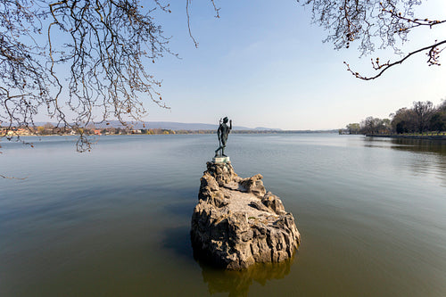 The old lake in Tata, Hungary with the statue of Saint John.