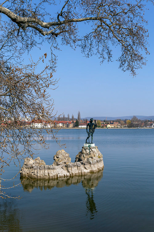 The old lake in Tata, Hungary with the statue of Saint John.