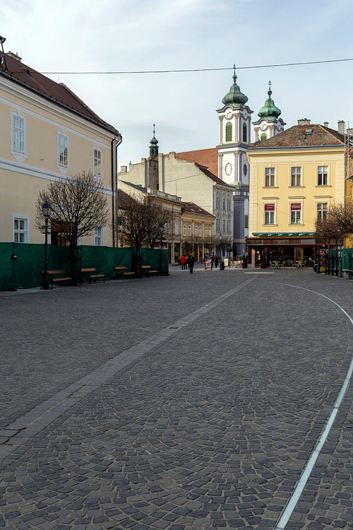 Cobblestone street in Székesfehérvár on a winter day.