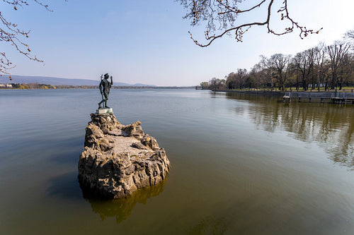 The old lake in Tata, Hungary with the statue of Saint John.