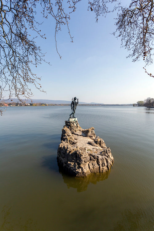 The old lake in Tata, Hungary with the statue of Saint John.