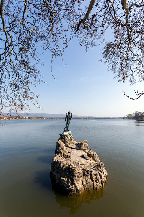 The old lake in Tata, Hungary with the statue of Saint John.