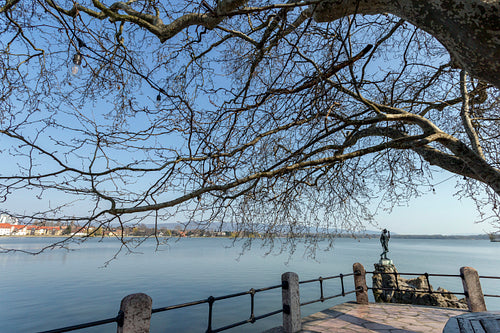 The old lake in Tata, Hungary with the statue of Saint John.