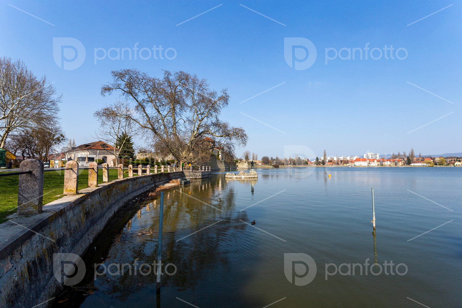 The old lake in Tata, Hungary with the statue of Saint John.