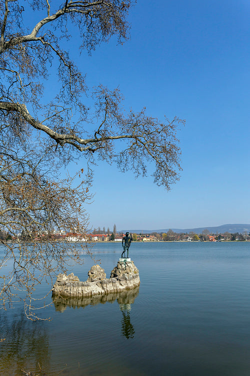 The old lake in Tata, Hungary with the statue of Saint John.