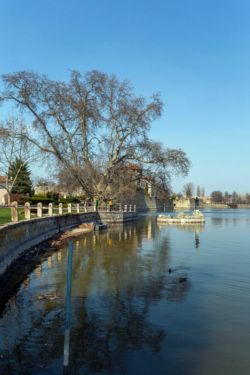 The old lake in Tata, Hungary with the statue of Saint John.