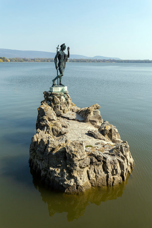 The old lake in Tata, Hungary with the statue of Saint John.
