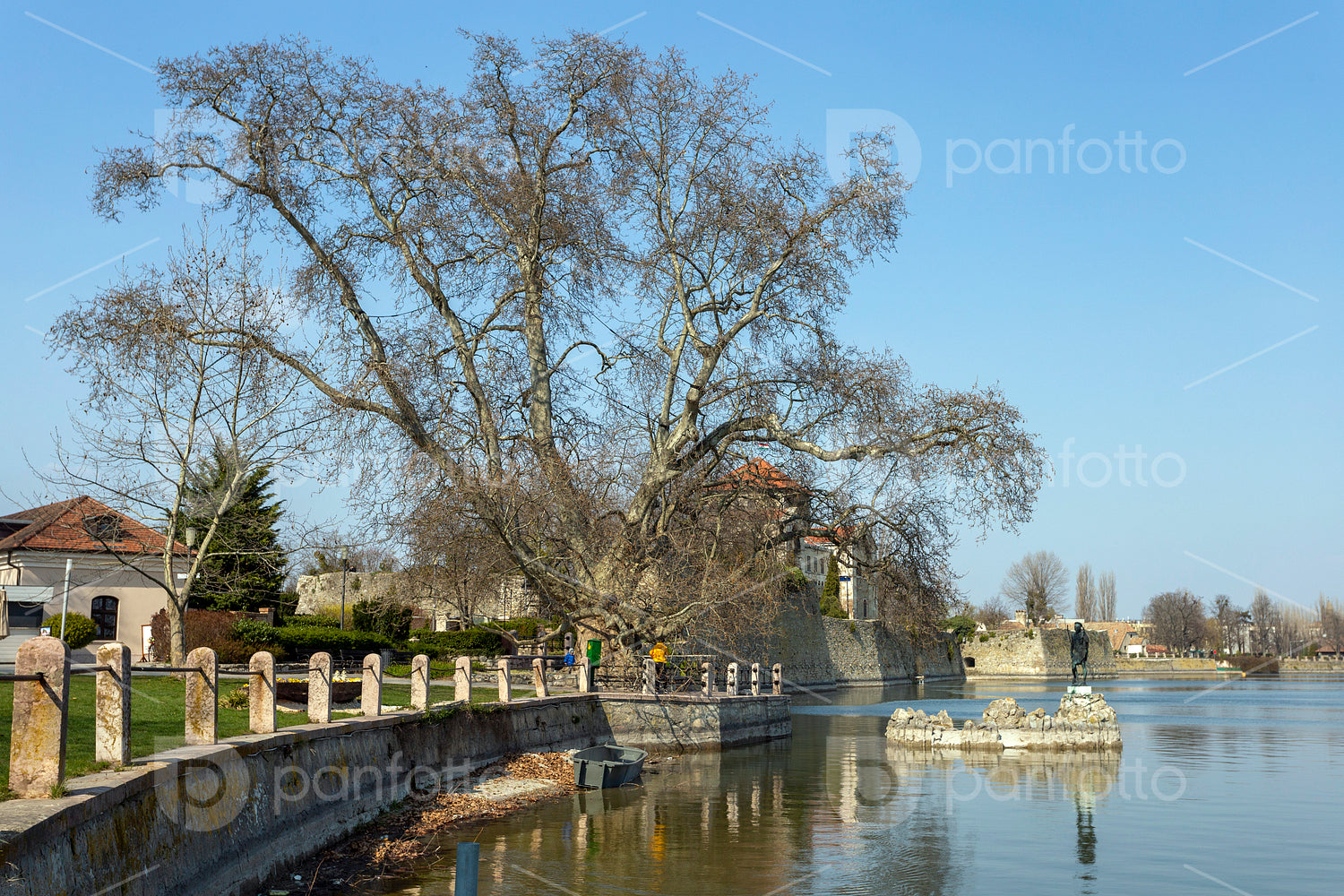 The old lake in Tata, Hungary with the statue of Saint John.